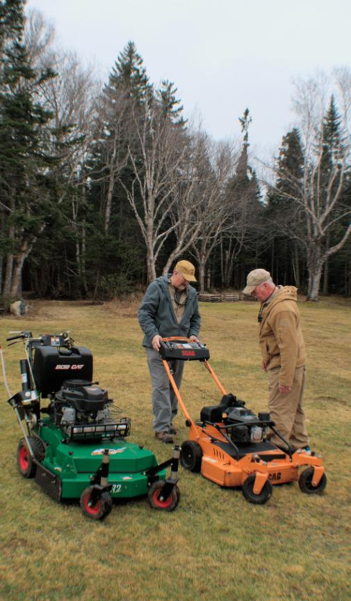Owners of P&R Mowing, expert lawn care professionals, posing with their mowers in Saint John